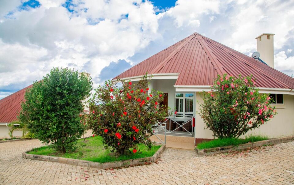 Executive Cottage exterior at A1 Hotel & Resort with Mount Meru in the background